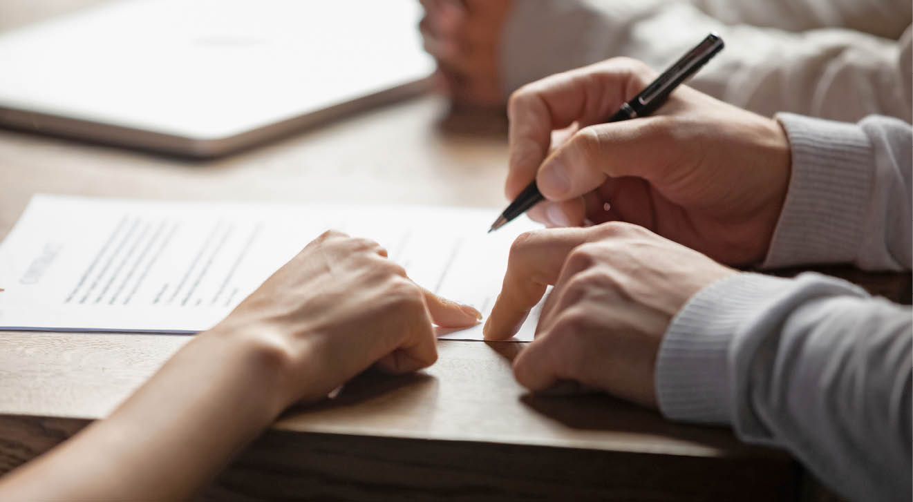 Solicitor pointing at insurance contract showing male client where to write signature sign sale purchase employment agreement at meeting make financial business deal, bank loan service, close up view