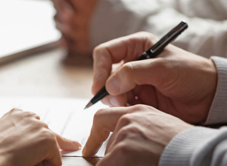 Solicitor pointing at insurance contract showing male client where to write signature sign sale purchase employment agreement at meeting make financial business deal, bank loan service, close up view