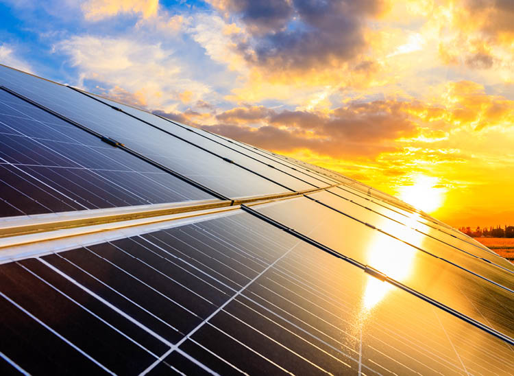 Photovoltaic solar panels on sunset sky background,green clean energy concept 